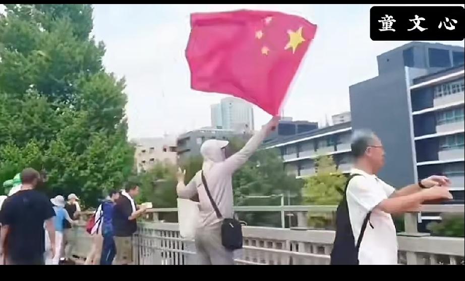 近日，一名中国小伙在日本街头挥舞着中国国旗，高呼“中国万岁！中华万岁！中国永存，