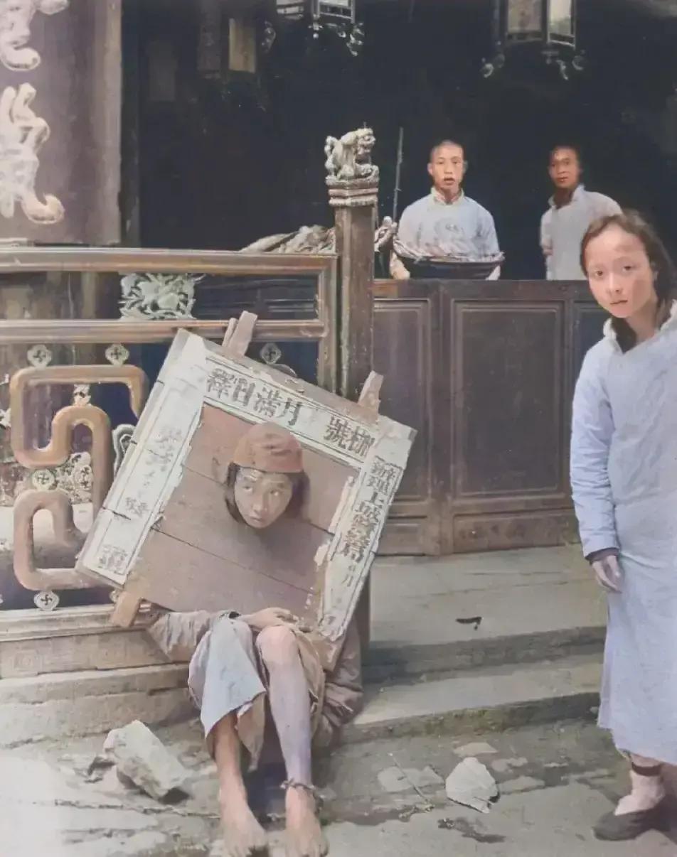 1906年，一个女囚犯脖子上戴着木枷锁，看样子被发配到边疆，准备上路，这一幕被外