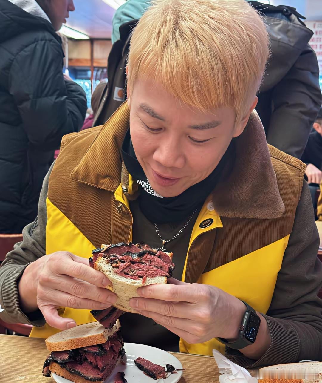 56岁陶喆在美国一家餐馆吃牛肉汉堡，他染了一头黄毛，整张脸看起来好奇怪，面相姨化