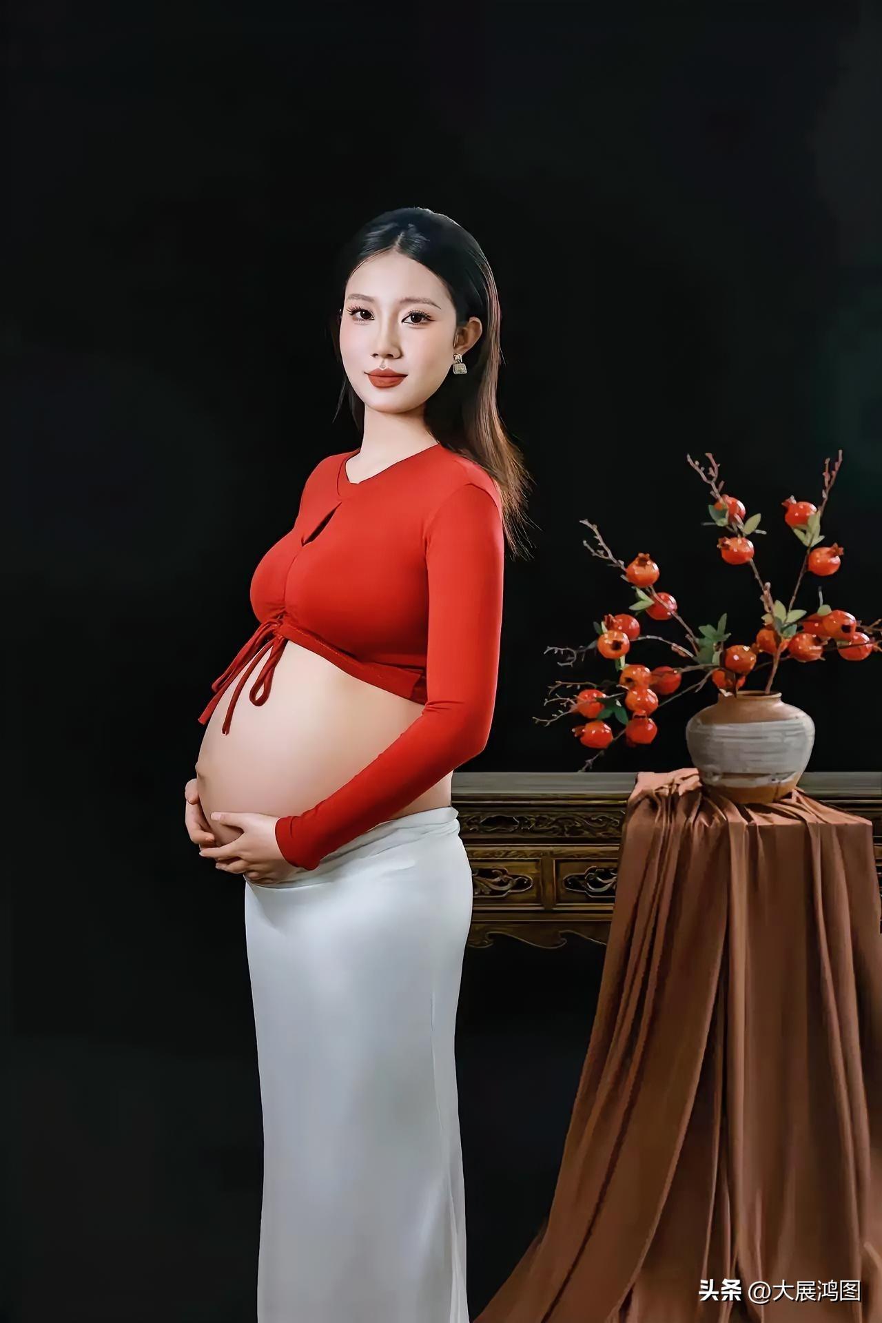 孕妈妈面带温柔微笑，身着红衣白裙，尽显静谧优雅之态。长裙孕妇照 孕妈妈自拍 温柔