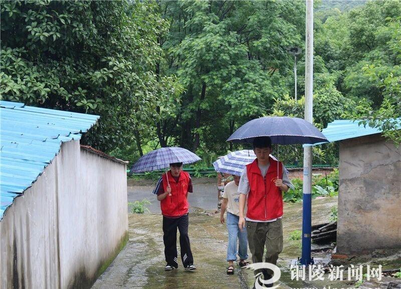 【冒雨走访暖“空巢”[话筒]】6月22日，义安区新桥办事处新建村“两委”成员走访