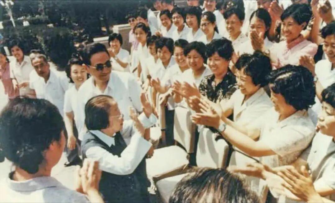 1984年，邓颖超在天津视察时与为她缝制丝绵袄的工人一一握手