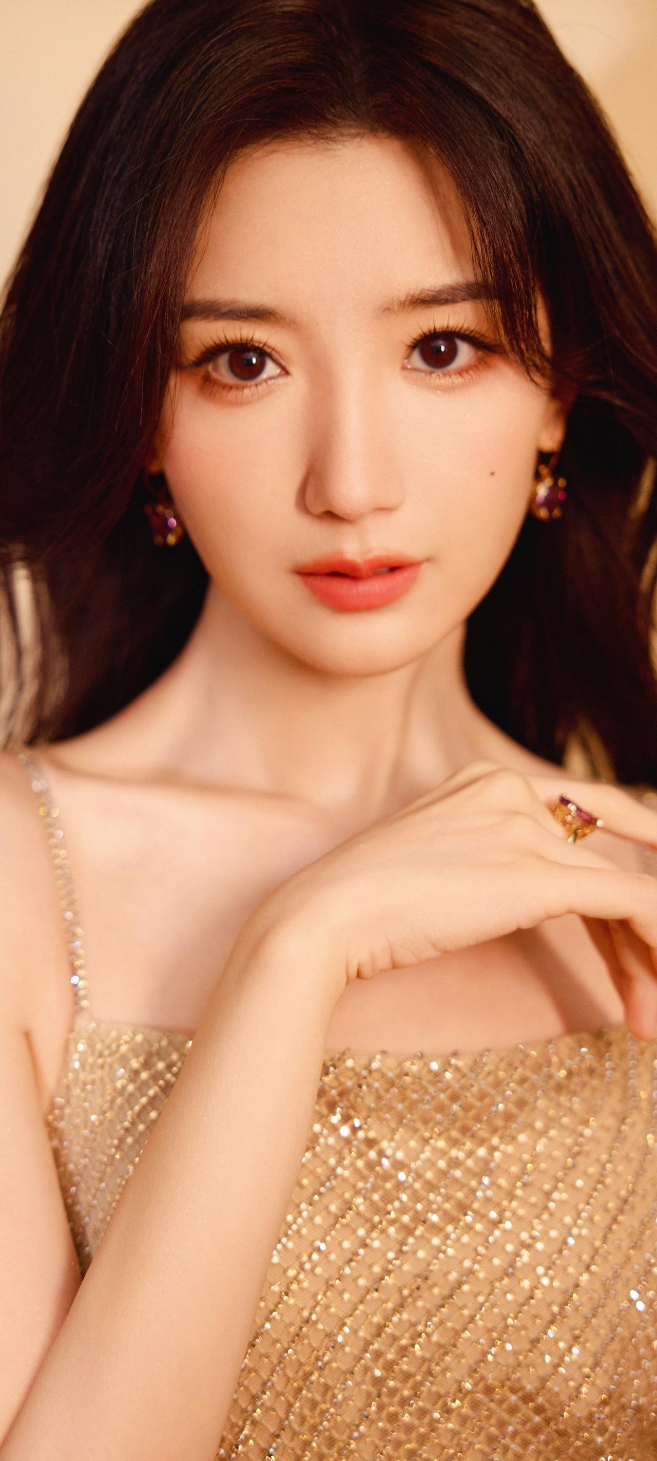 《金裙倩影》
金缕裁裙缀碎光，
青丝漫卷惹风扬。
指尖轻触眉间月，
腕底微凝颈上