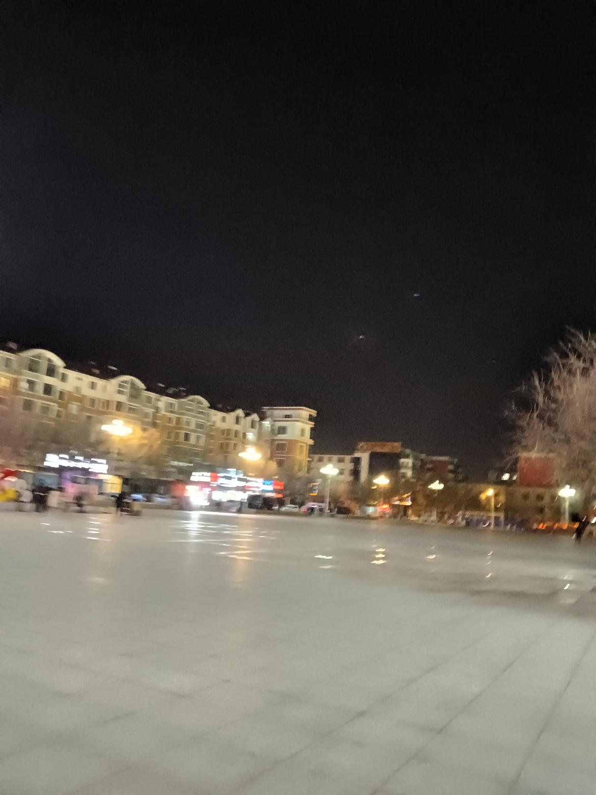 夜晚的广场，灯火阑珊，人影绰约，静谧而美丽。