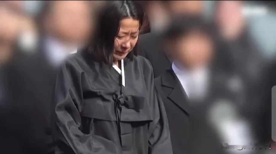 李善均拼尽全力保护的两个儿子回来送他最后一程。
14岁的长子手捧爸爸遗照走在棺木