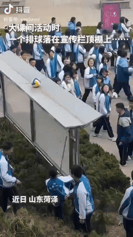 近日，山东菏泽，大课间活动时一男生抛排球，没想到排球正好落在了公告栏的顶棚上，接