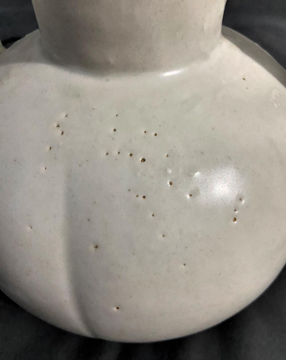 景德镇窑白釉蚀孔成因短评

这件景德镇窑白釉器，釉面蚀孔并非人为酸蚀所致，而是柴