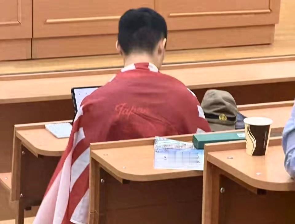 这个叫陈宇昕的精日份子，已被莫斯科大学开除，并遣返回国。坐在教室第一排，身披旭日