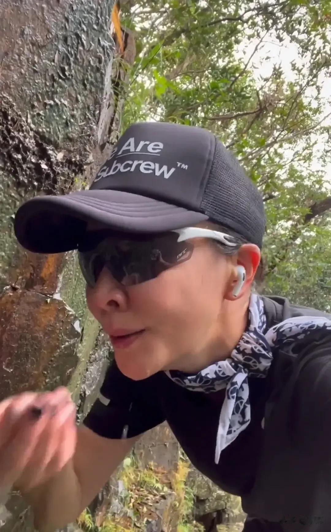 刘嘉玲上山跑步，突然发现顺峭壁流下的山泉水，便来了兴致，手捧泉水喝了起来！

然