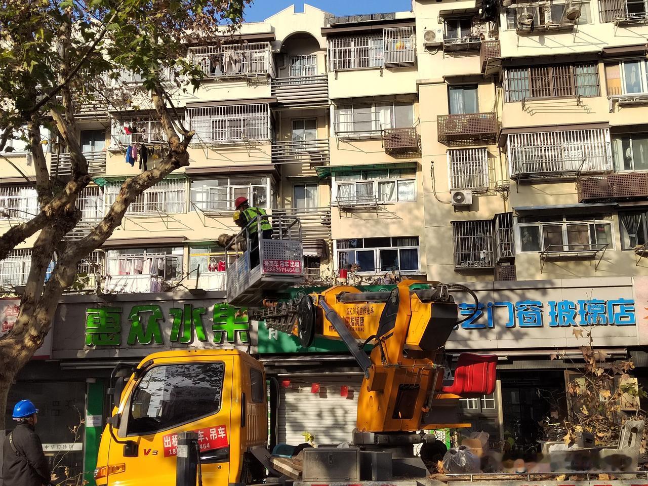 昨天下午路过建邺区茶南大街附近，看到园林工人正在对马路边的梧桐树进行修枝作业。路