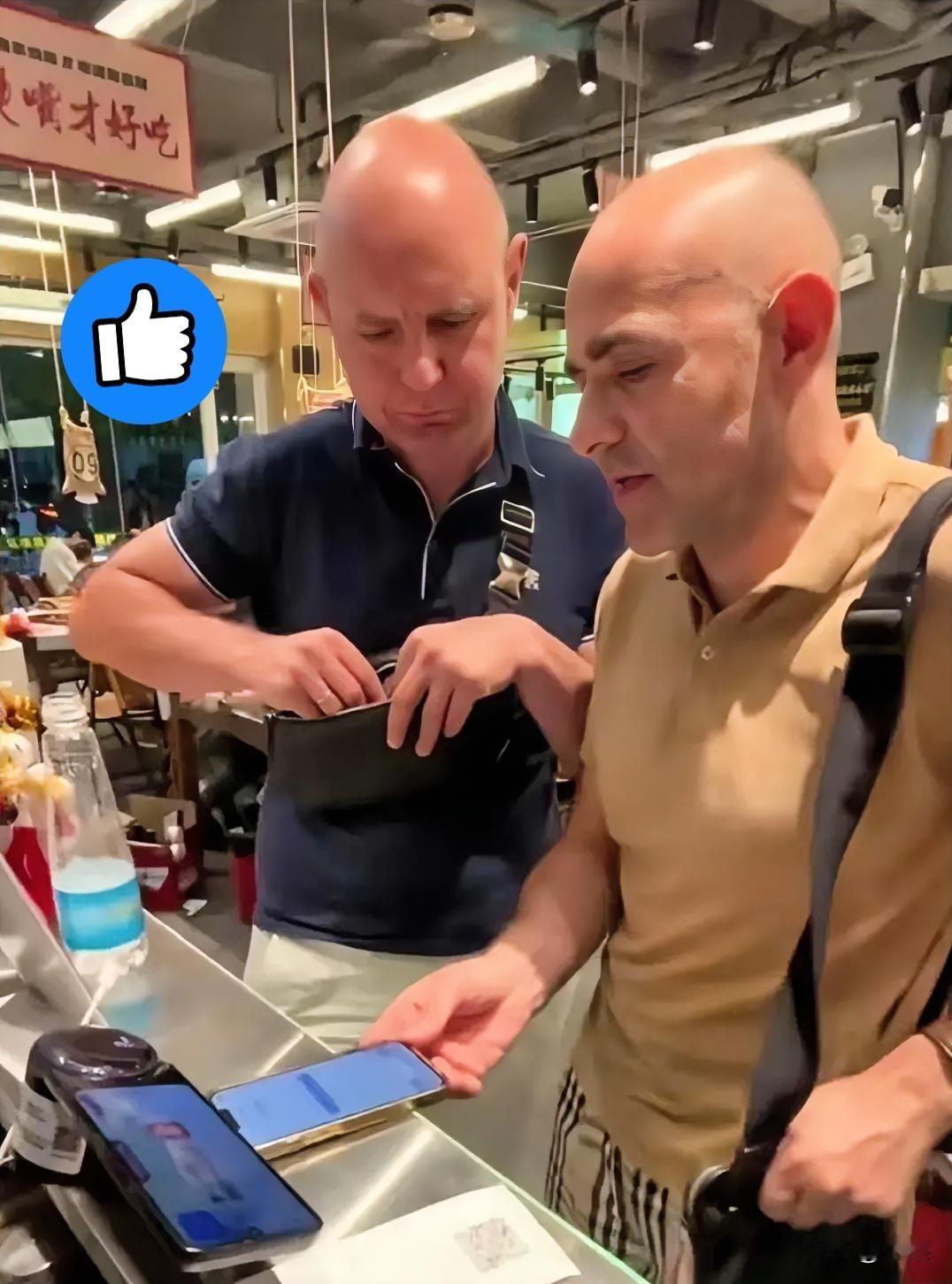 这两个老外在南昌吃烧烤，前台结账时发现手机扫码付不了，身上也没人民币现金。老板见