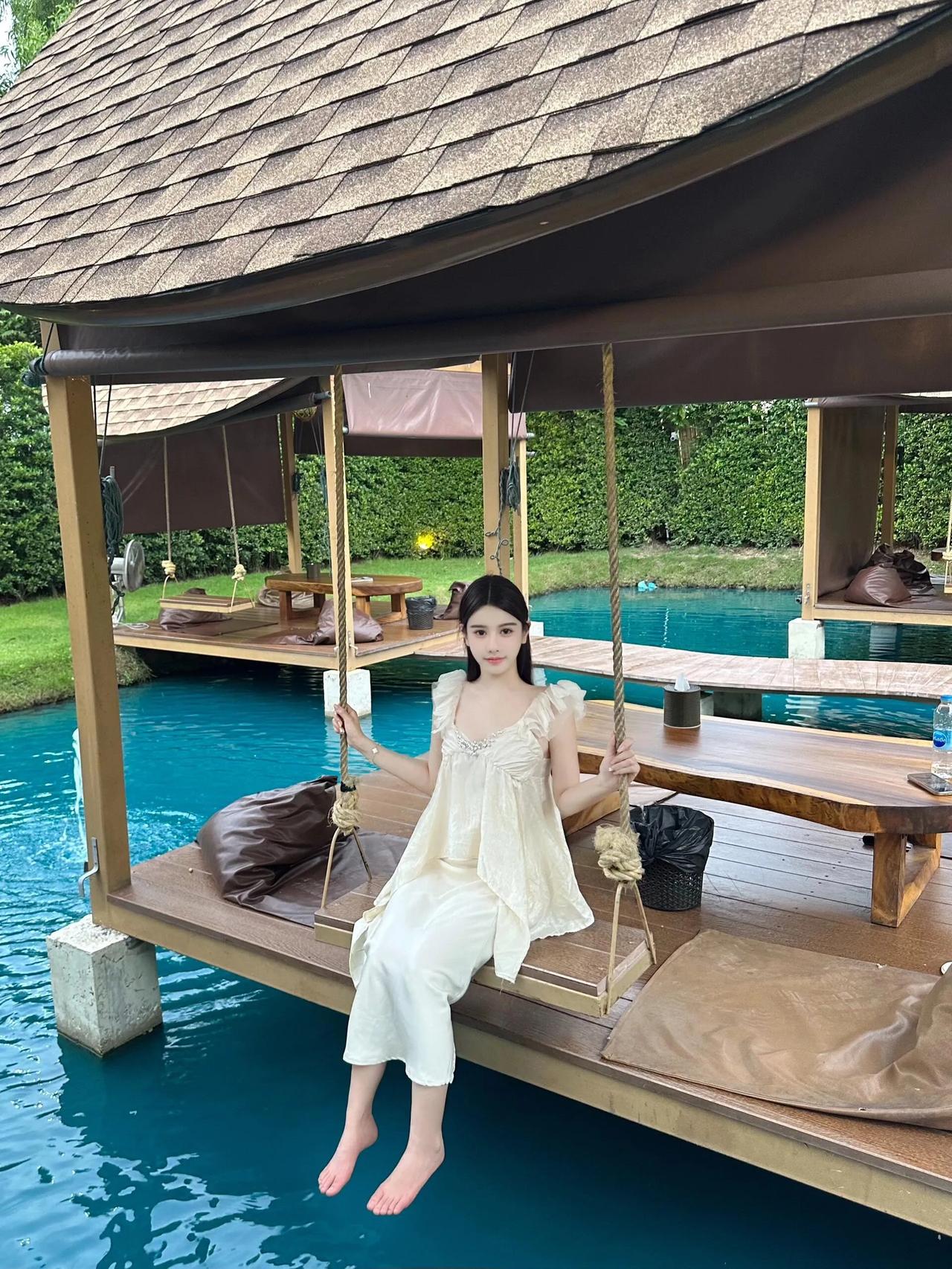 碧波荡漾水清浅，美女倚栏笑嫣然。