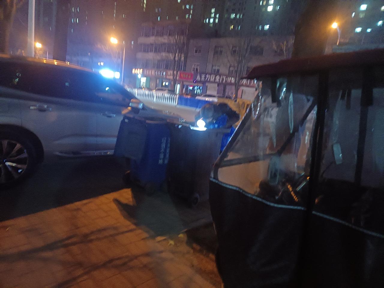 晚上和老婆去散步，一辆带音响的三轮车停在路边，车主走到路边垃圾桶，把头探进垃圾桶