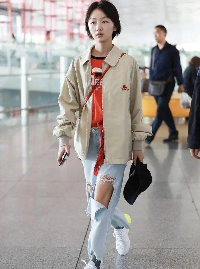 被周冬雨的纯素颜惊艳，皮肤状态简直好到爆，穿卡其色夹克+破洞牛仔裤，内搭红色印花