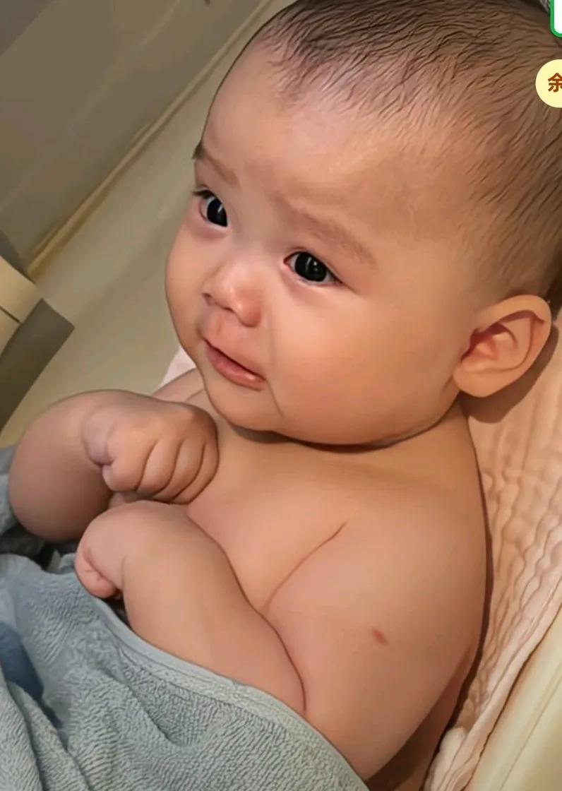 宝宝体验第一次淋浴，害怕的双手紧握轻声难过，大眼睛圆瞪，看着好萌的表情，
网友说