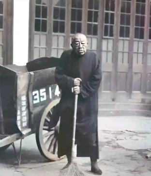 1951年，上海街头，一个84岁的老头拄着扫帚站在"大世界"门口。三年前老蒋还给