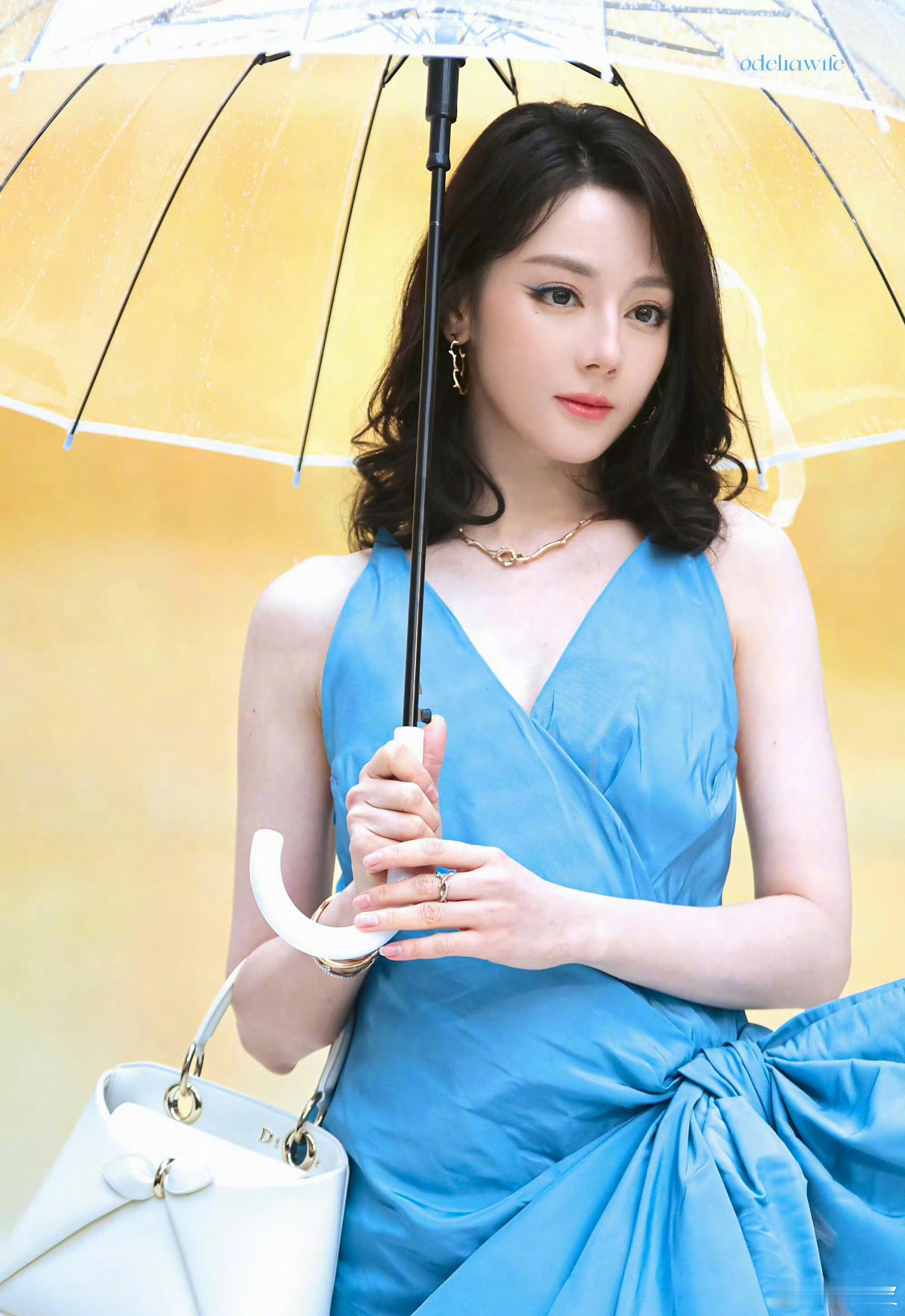 迪丽热巴金刚发型雨中蓝裙，复古卷发，是画报里走出来的美人，浓颜配复古，慵懒又高级