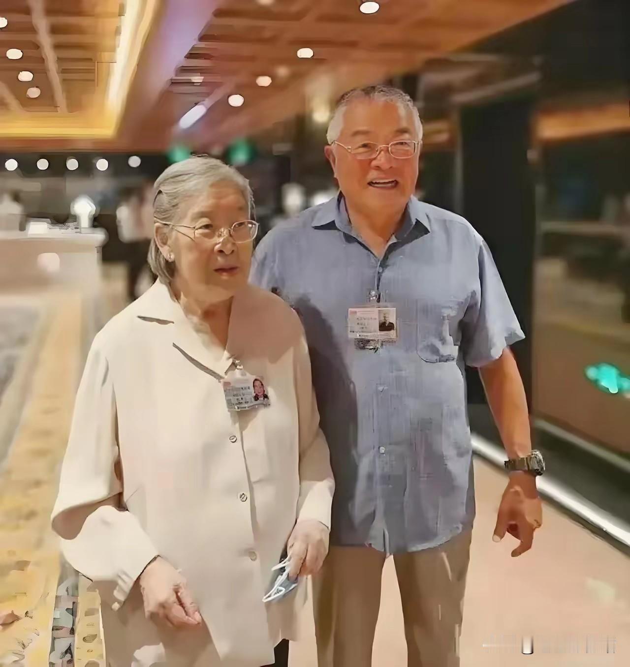 这张照片拍摄于建党100周年系列活动期间，二人佩戴活动证件，是红色后代参会途中的