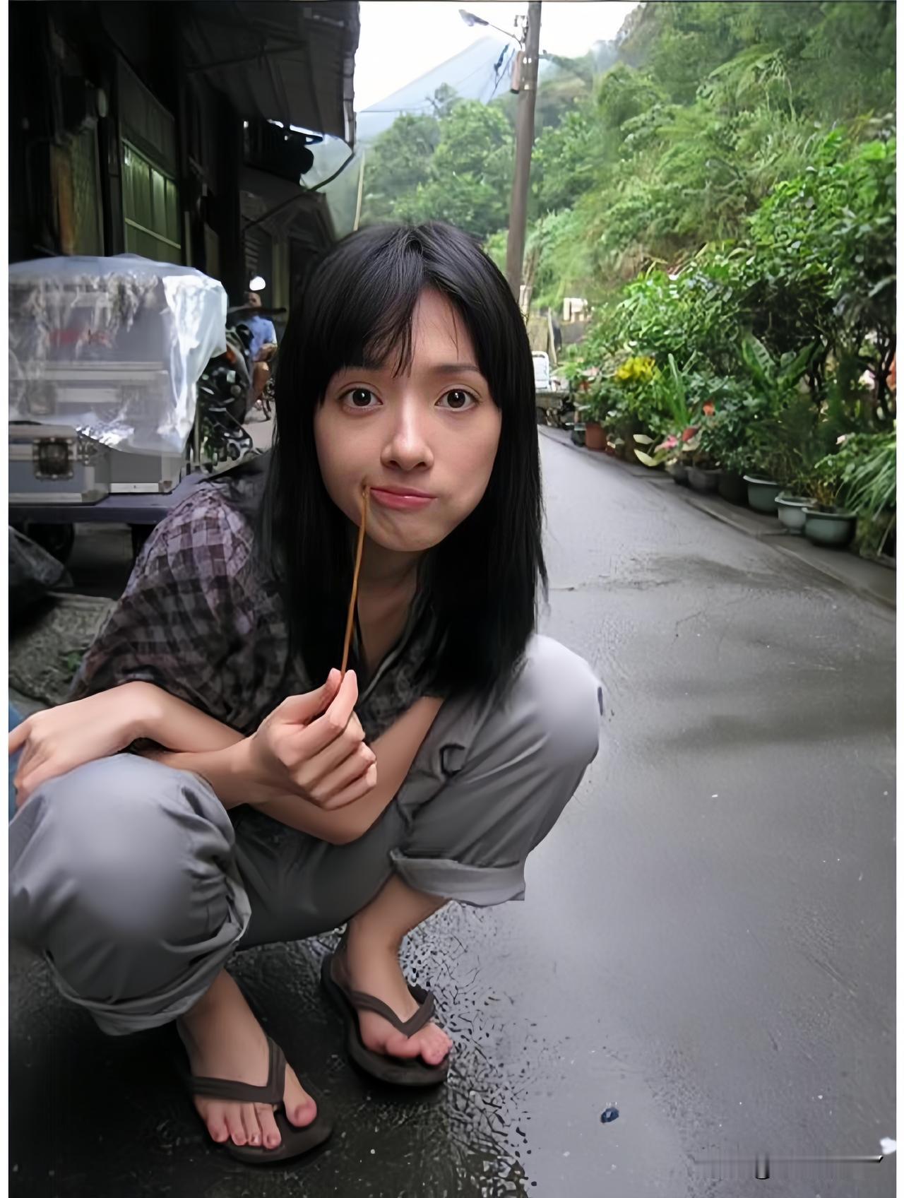 二零零一年，台湾，蹲在沥青路面咬着牙签的郭碧婷，时年十七岁。留着标志性黑长直齐刘