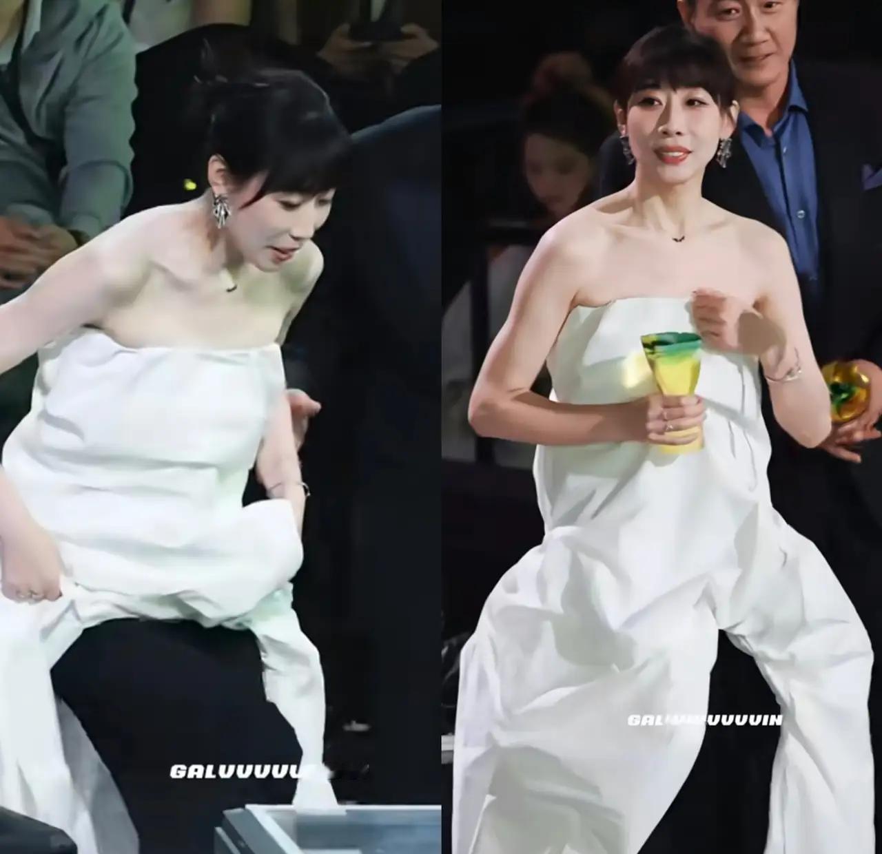 任素汐根本没穿裙子。
她领奖时那身“长裙”，走近看全是裤子。
上半身是柔美的斜裁