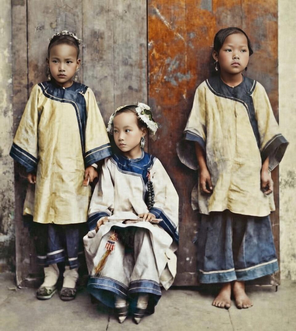 1907年，武昌，中间端坐的小女孩，是一位家境优渥的千金小姐，她身着华服、头戴珠