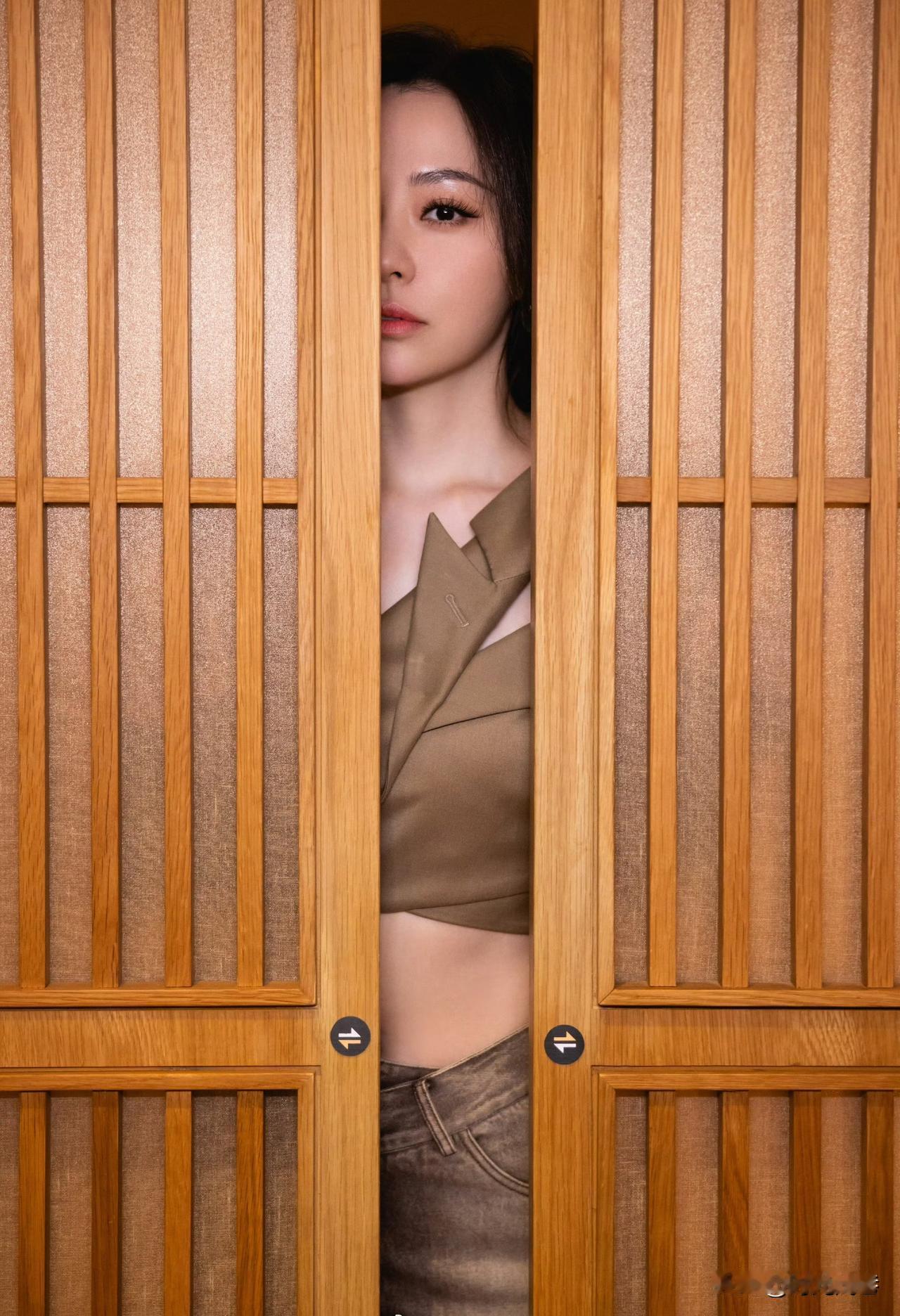 这位被门挡住一半容颜的女星大家看的出她是谁吗？她是一位优秀的歌手！