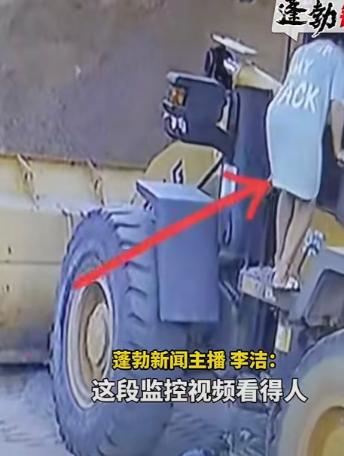 工地空地上停着一辆铲车，一名男子蹲在车身底盘下面，低着头专心检修零件，周围没放任