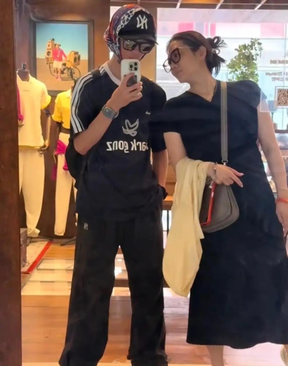 杨威一家在韩国旅游，杨云陪着16岁大儿子逛街买衣服，母子俩在镜子前面自拍，杨阳洋