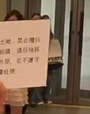 SM大楼下工作人员举的中文警示牌 ​​​