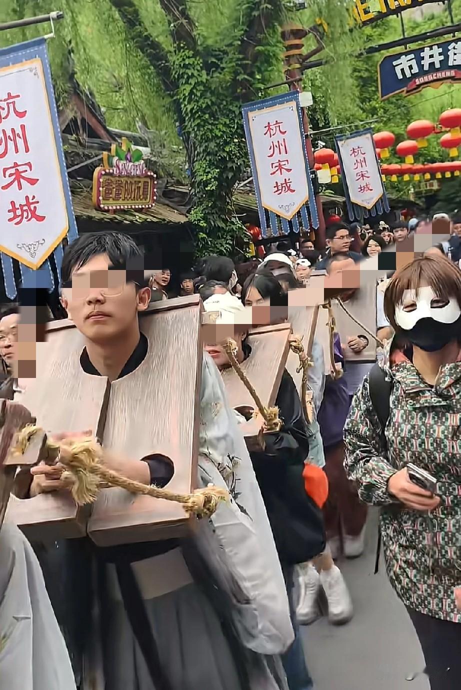 游客体验当囚犯游街？

5月4日，杭州宋城景区内，一群年轻游客一字排开，正在体验
