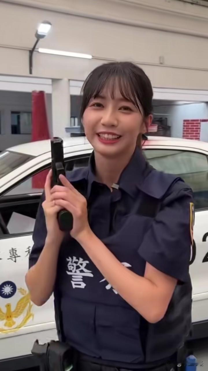 干一行，爱一行！
瞧瞧这位来自台湾的女警察，手持枪械，笑容满面地维护着社会治安。