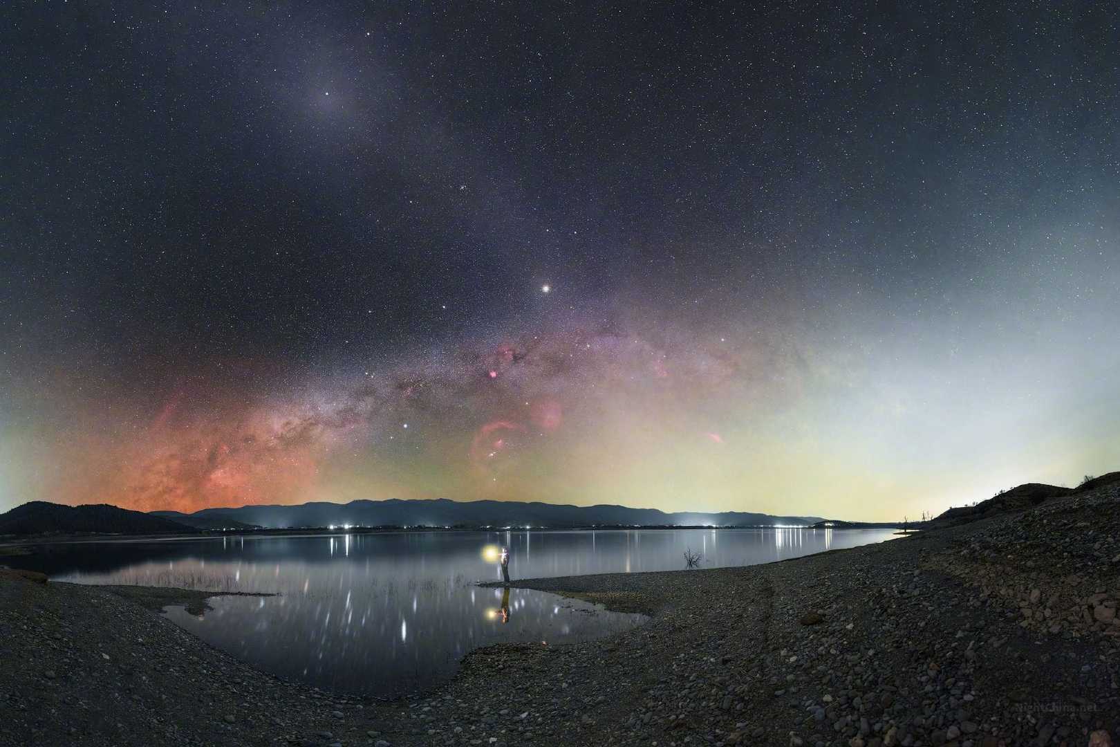 黄道光像一道被遗忘在天边的暮色余晖，斜斜地挂进银河里，将整片冬夜染上了暖意。湖面