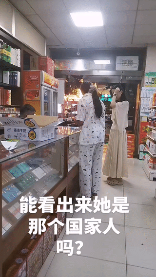 两名年轻女子晚上来一家超市买东西。
其中有一名女子皮肤黝黑，长得有点像印度？巴基