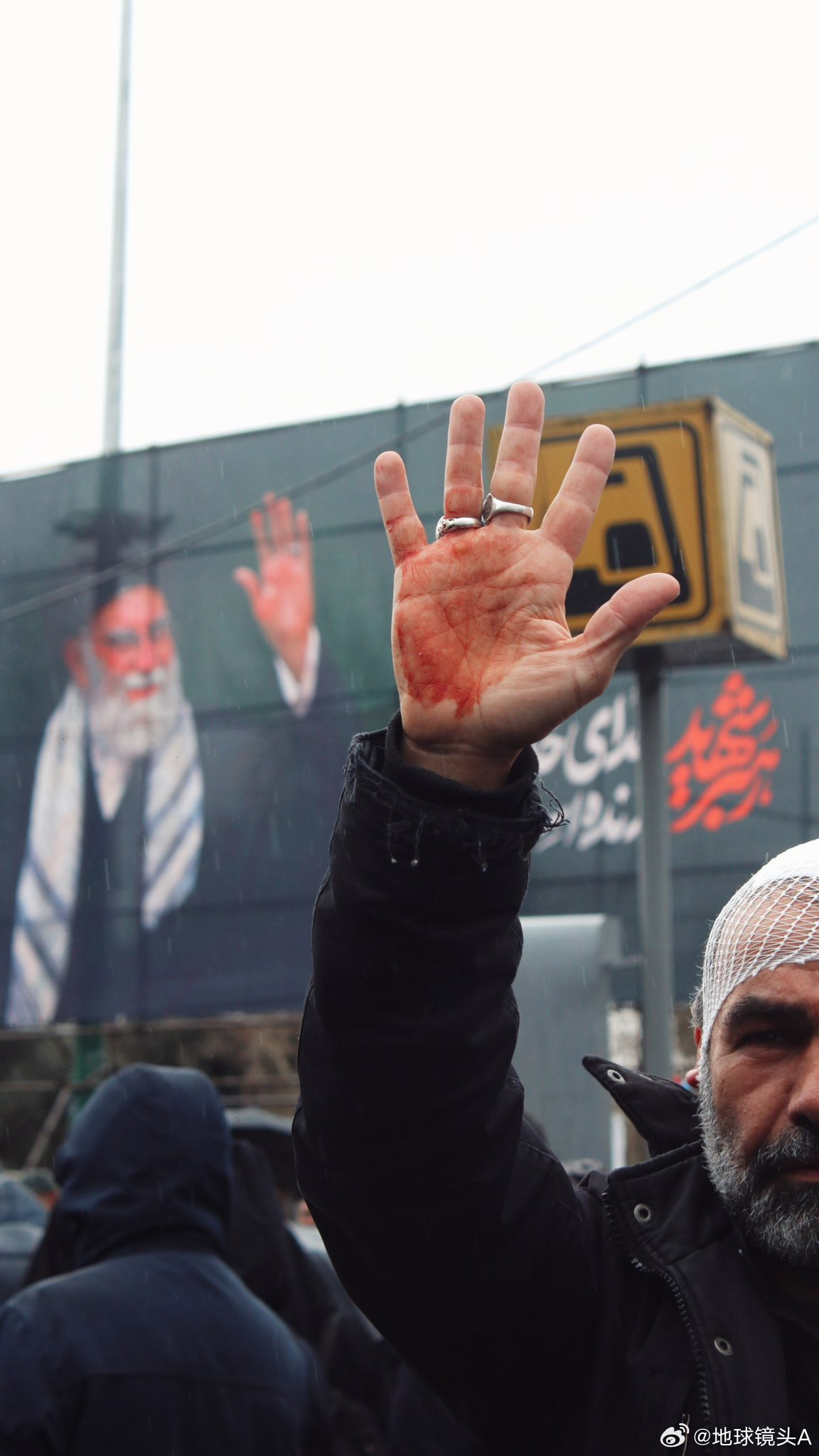 哈梅内伊遗体手紧握成拳 在今天伊朗的圣城日集会上，右下角这面被展开的伊朗国旗，被