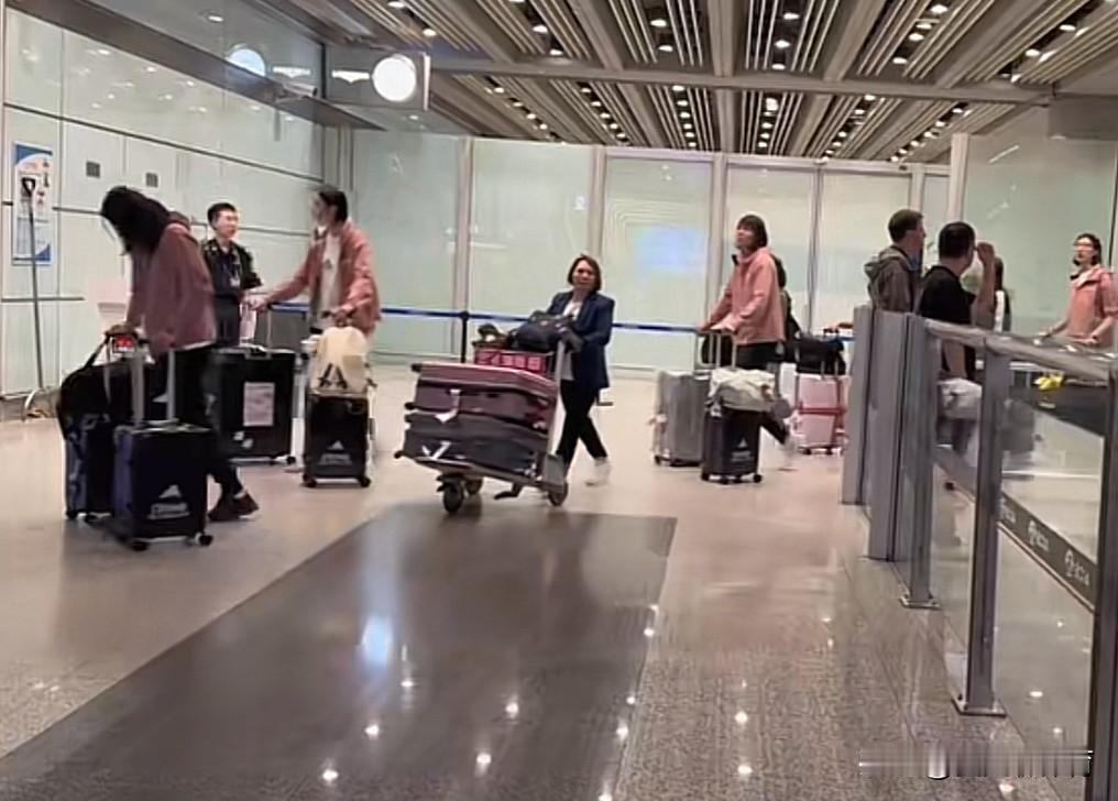 中国女排落地北京机场✈️姑娘们每个人都拖着2个大黑色行李箱，看到了王梦洁穿着白色