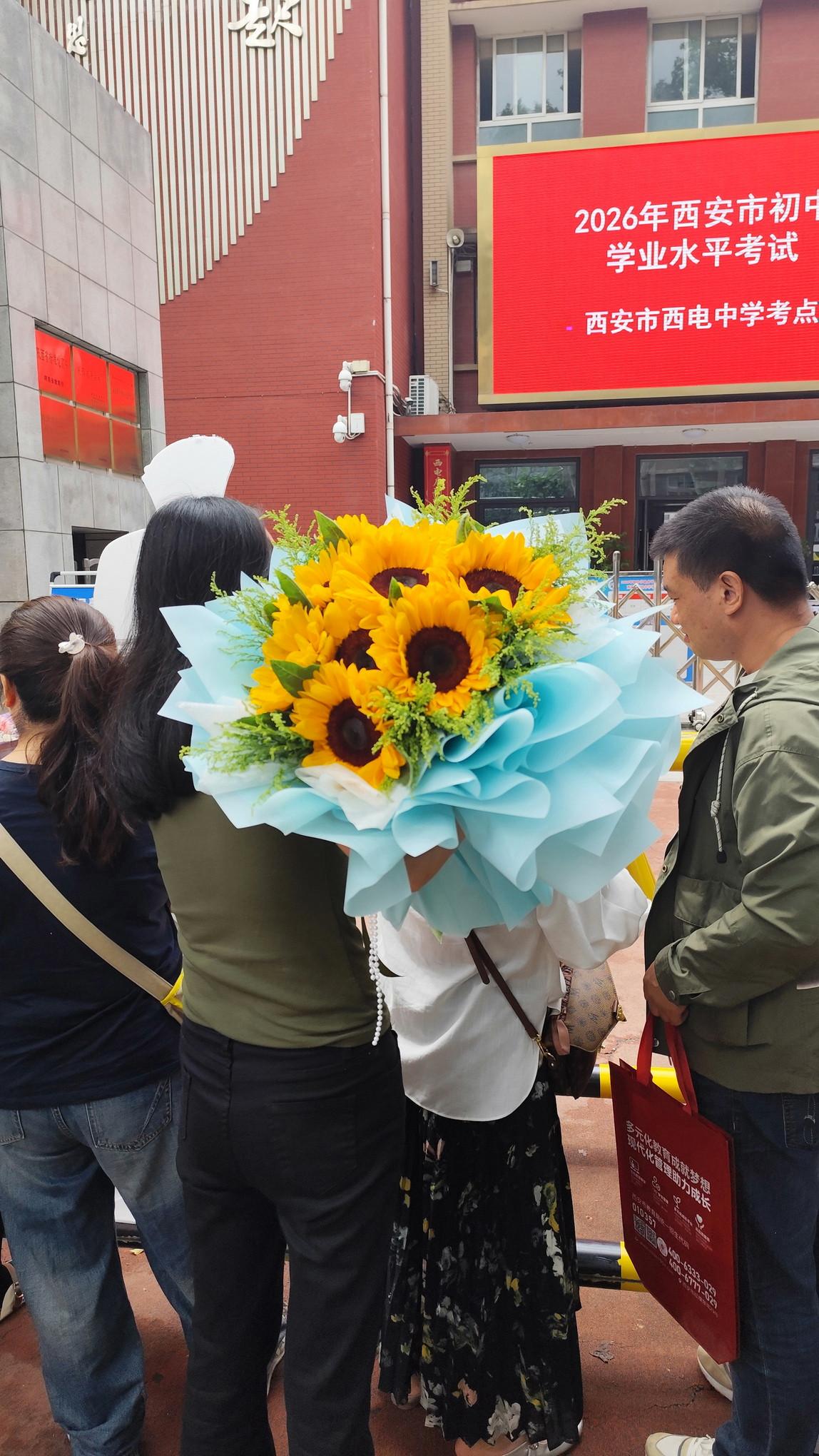 西安中考今天上午总算落幕了！考场外直接变成“向日葵批发市场”，家长们几乎人手一束