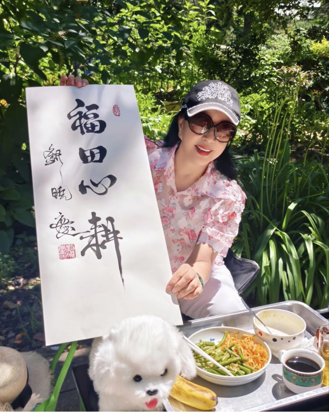 6月夏至时节，刘晓庆更新了社交媒体。双手托举着自己写的书法作品在田园式的豪宅前拍