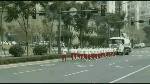 原来她们会跑。
大街上，一队暴走族举着红旗气宇轩昂地在机动车道上走着。一辆洒水车