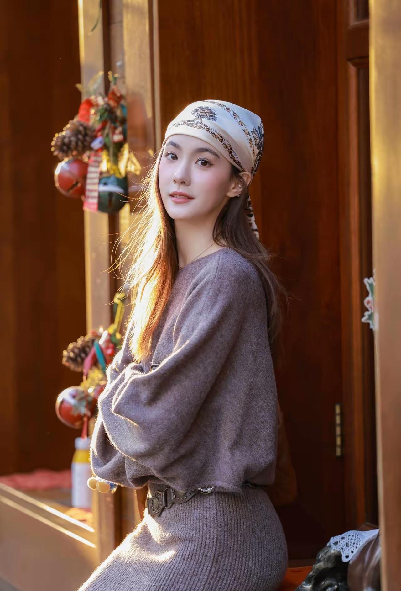 冬日暖阳下的少女，头戴围巾，笑容甜美，温暖如春。