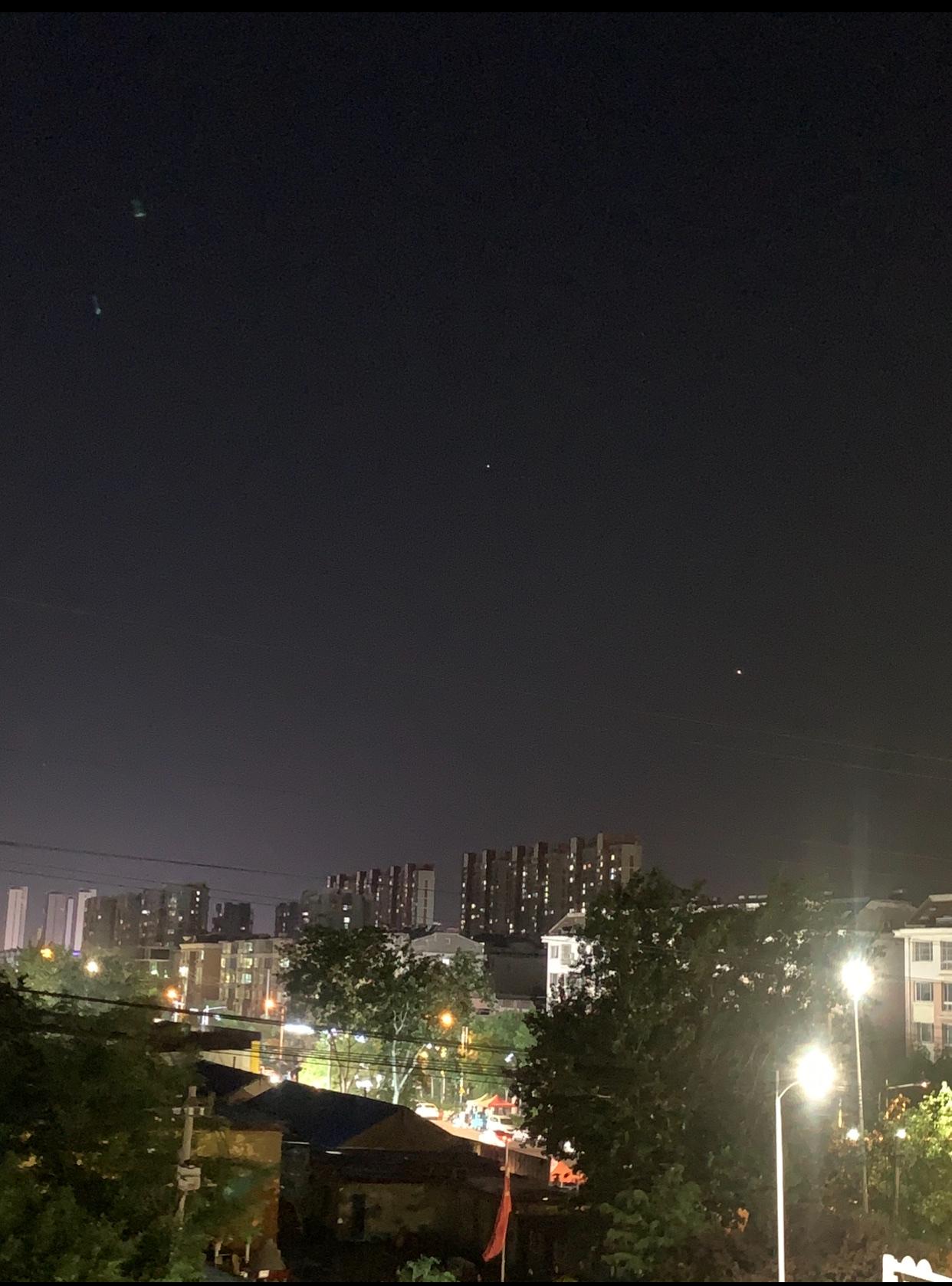 小城夜景（隔窗拍照）
夜幕降临，窗外点亮了斑斓的灯光。街道上的路灯如同温柔的守护