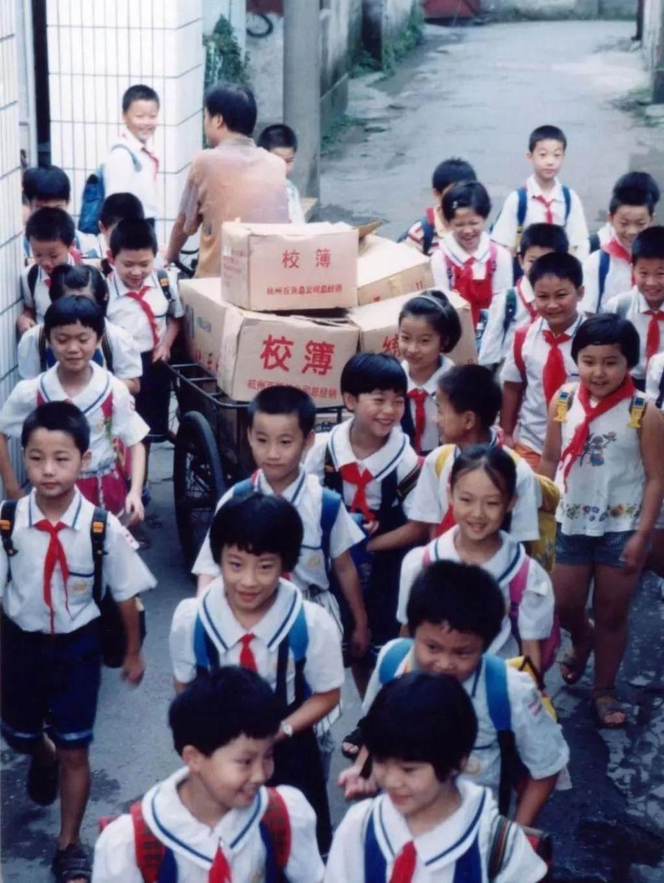 这是宗庆后踩着三轮车给学校送校簿的背影，1986年的杭州街头，这个蹬着三轮车的中