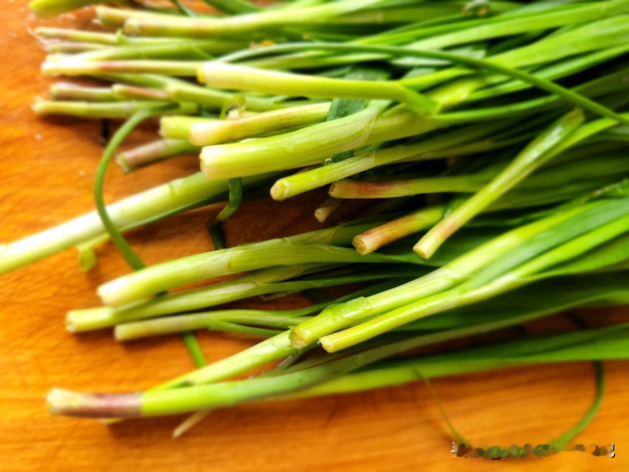 去早市买菜，碰到很多农户自产自销的新鲜蔬菜，我花两块钱买了一把红根韭菜，中午包水