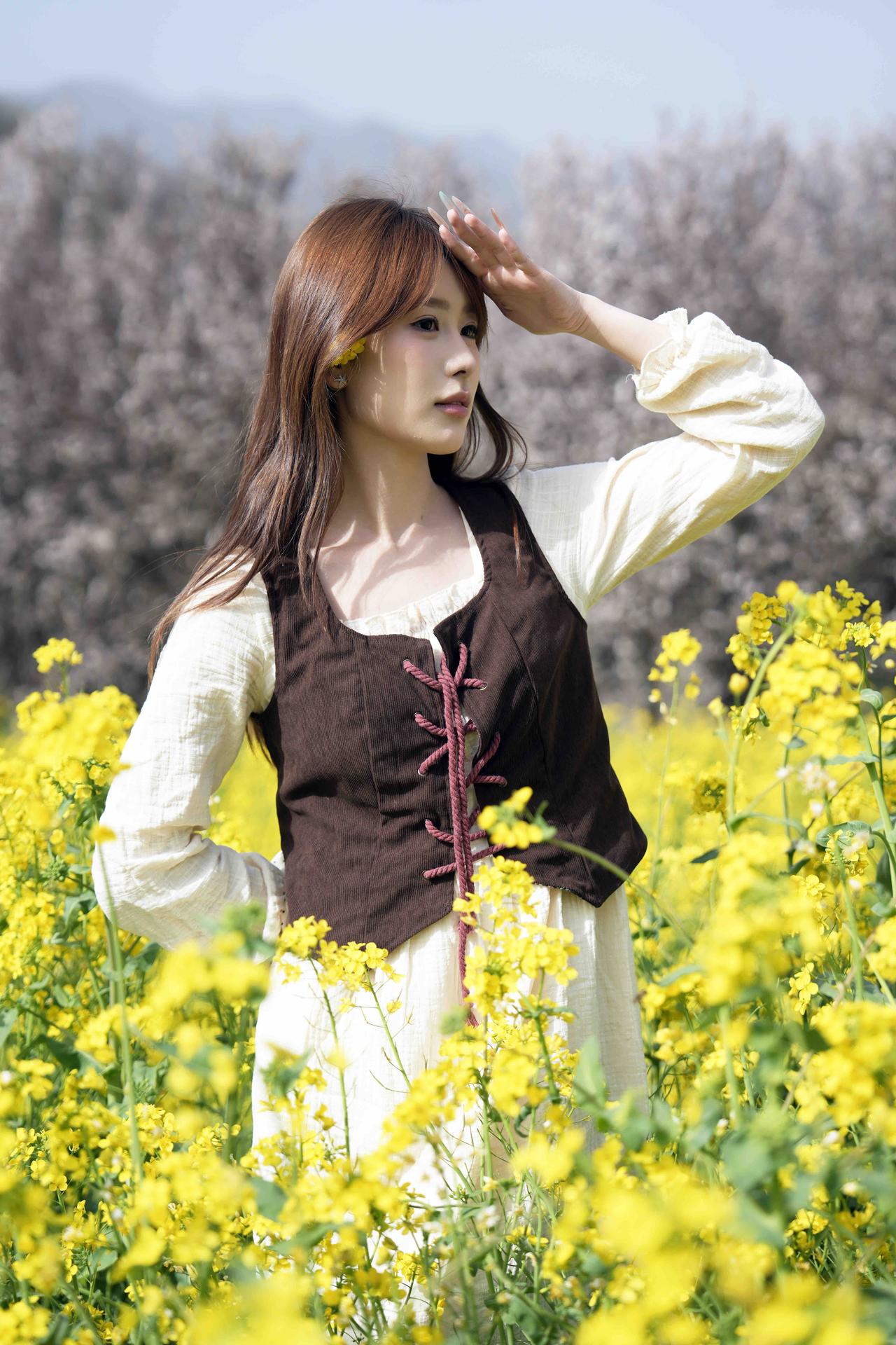 在花海中，她优雅的姿态与自然融为一体，仿佛一幅美丽的画卷。