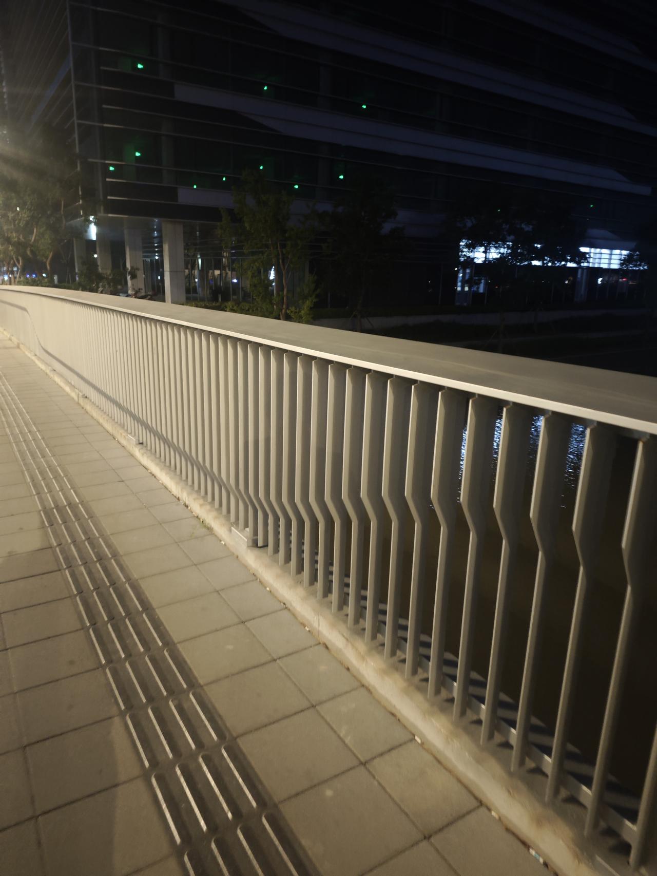 夜里散步路过一座新建的跨河桥，平整的步道搭配通体钢制护栏，工整利落，看得心里生出