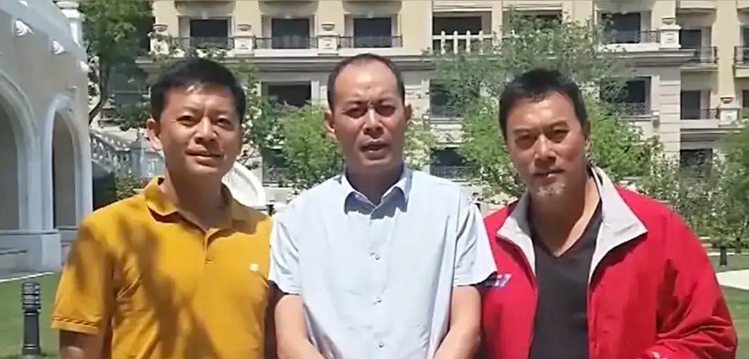 身穿黄色上衣的是何政军英俊帅，中间穿白色衣服，个子高高的是张光北，身穿着红色外套