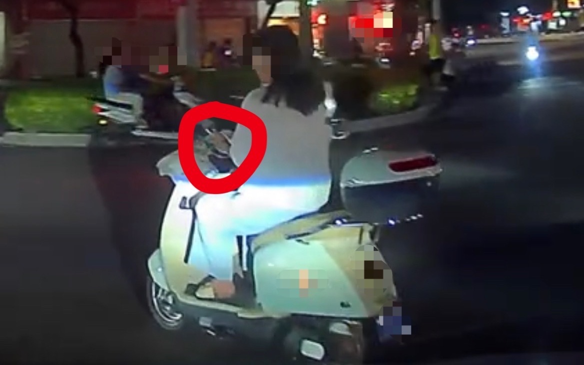 【玉林一女子骑电车转弯过红绿灯还看手机】9月2日晚，玉林市城区一名女子骑电动车转