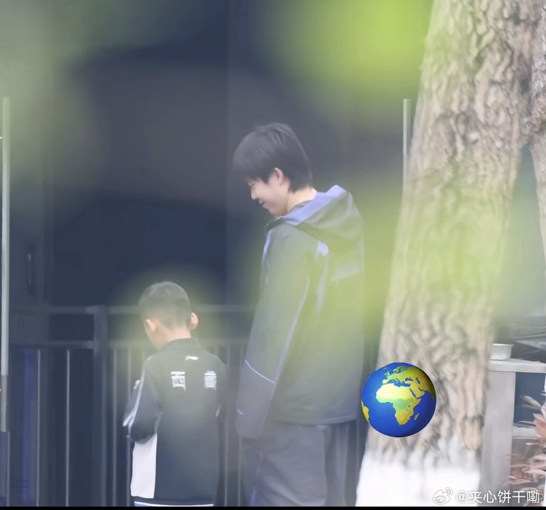 大头笑咪咪的等着小孩哥打开小天才手表的相机拍合照