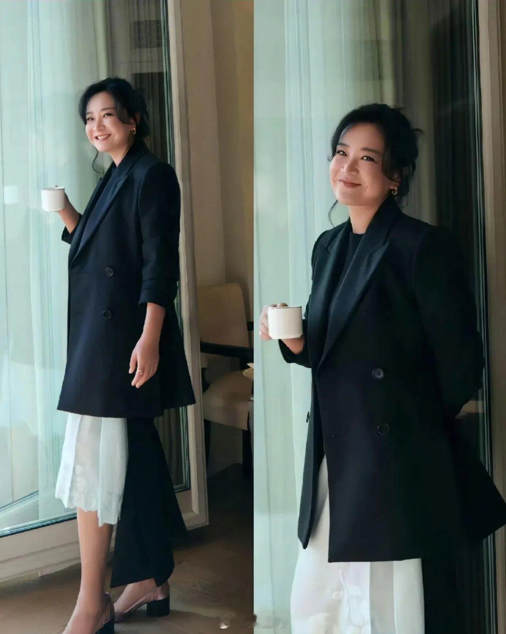 贾玲亮相米兰时装周的造型曝光，贾玲头发盘了起来，穿着黑色不规则西装，搭配白色裙子