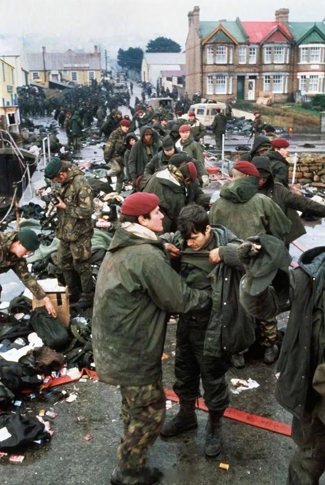 照片中的历史[超话] 英军第2伞兵营A连的士兵们在码头上搜查阿根廷战俘，随后这些