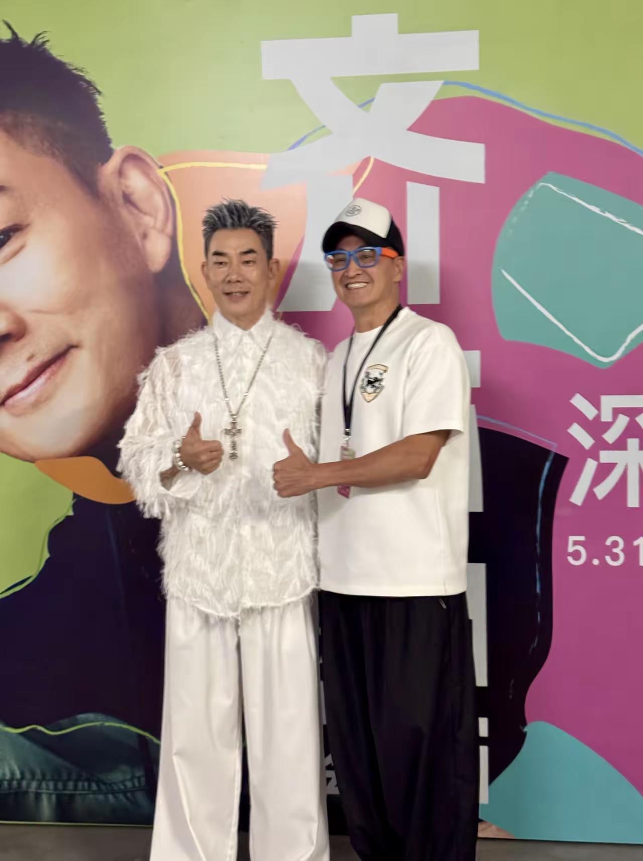 两位大哥站在一起，开心地比着大拇指。真没想到小齐都60岁了。都是我们八零后的偶像